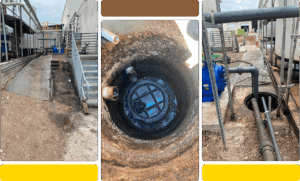 View down a large, rusty pipe showing water inside.
